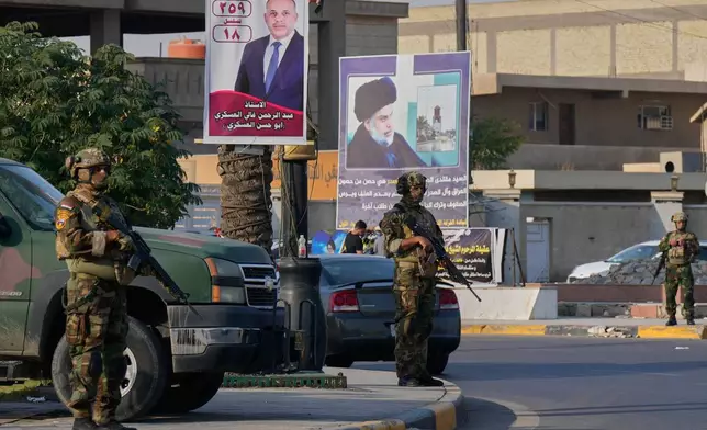 Iraqi army soldiers patrol Sadr City, Baghdad, during parliamentary elections, Tuesday, Nov. 11, 2025. (AP Photo/Hadi Mizban)