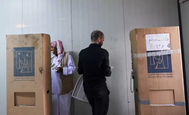 Displaced Yazidis vote ahead of Iraq's parliamentary elections, set for Nov. 11, at a polling station in the Sharia camp near Dohuk, in Iraq's semi-autonomous Kurdish region, Sunday, Nov. 9, 2025. (AP Photo/Rashid Yahya)