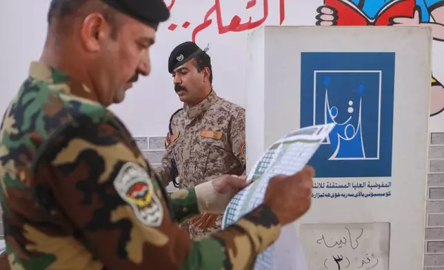 Iraqi security forces gather to cast their ballot during a special voting session ahead of Tuesday's parliamentary election in Basra, Iraq, Sunday, Nov. 9, 2025. (AP Photo/Ali Rahim)