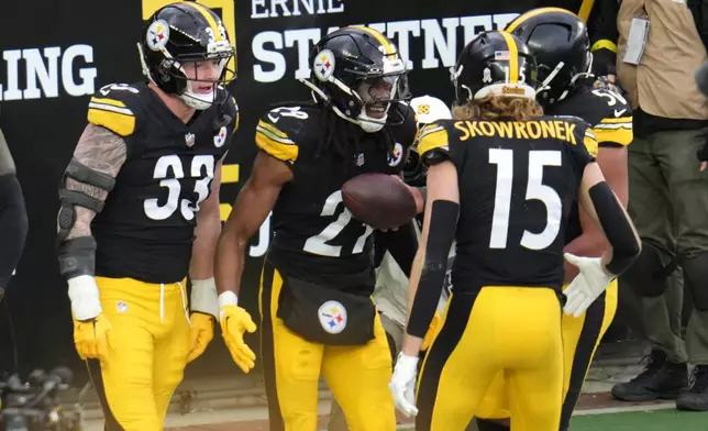 Pittsburgh Steelers safety Kyle Dugger, center, celebrates after scoring a touchdown against the Cincinnati Bengals during the second half of an NFL football game Sunday, Nov. 16, 2025, in Pittsburgh. (AP Photo/Gene J. Puskar)