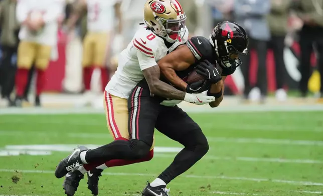 Arizona Cardinals wide receiver Michael Wilson, right, runs against San Francisco 49ers cornerback Renardo Green (0) during the first half of an NFL football game in Glendale, Ariz., Sunday, Nov. 16, 2025. (AP Photo/Ross D. Franklin)