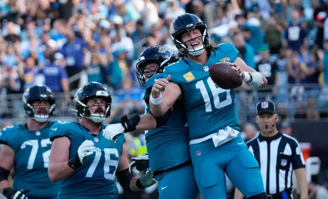 Jacksonville Jaguars quarterback Trevor Lawrence (16) celebrates a touchdown run during the second half of an NFL football game against the Jacksonville Jaguars, Sunday, Nov. 16, 2025, in Jacksonville, Fla. (AP Photo/John Raoux)