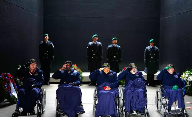 United States World War II veterans, from left, PFC Hilbert Margol of the Battery B 392nd Field Artillery Battalion 42nd Infantry Division, Lt. Col. Enoch Woodhouse of the 332nd Fighter Group 15th Air Force, Col. Frank Arthur Athanason of the 178th 3rd Replacement Depot, Pat Gideon Kantor of the 3804th Quartermaster Truck Company and Pfc. Fred J. Nungesser of the M Company 334th Infantry Regiment 84th Infantry Division salute after a wreath laying ceremony at the German Defence Ministry in Berlin, Germany, Monday, Nov. 10, 2025. (AP Photo/Markus Schreiber)