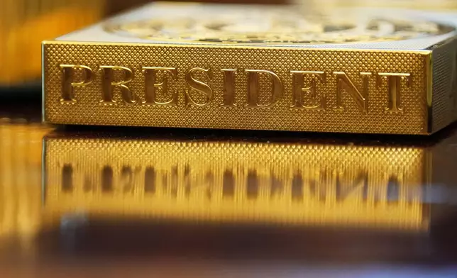 A item labeled "President' sits on the Resolute Desk as President Donald Trump attends the swearing-in of U.S. Ambassador to India Sergio Gor in the Oval Office of the White House, Monday, Nov. 10, 2025, in Washington. (AP Photo/Jacquelyn Martin)