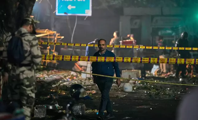 Security officials inspect the site after a car explosion near the historic Red Fort in New Delhi, India, Monday, Nov. 10, 2025. (AP Photo/Manish Swarup)