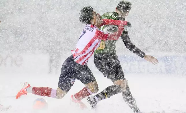 Atletico Ottawa's David Rodríguez, left, loses his footing as he crashes into Atletico Ottawa's Monty Patterson, right, during second-half Canadian Premier League finals soccer match action in Ottawa, Ontario, Sunday, Nov. 9, 2025. (Spencer Colby/The Canadian Press via AP) I