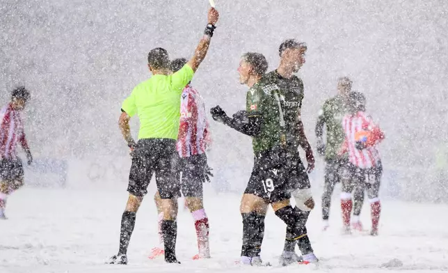 Cavalry FC's Mihail Gherasimencov (19) complains to a referee, center left, after being issued a yellow card during second-half Canadian Premier League finals soccer match action against Atletico Ottawa in Ottawa, Ontario, Sunday, Nov. 9, 2025. (Spencer Colby/The Canadian Press via AP) I