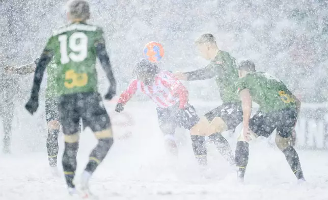 Atletico Ottawa's Kévin David Nogueira Carvalho Dos Santos (19) heads the ball as Cavalry FC's Eryk Kobza (24) fights to gain possession during second half Canadian Premier League finals soccer action in Ottawa, on Sunday, Nov. 9, 2025. (Spencer Colby/The Canadian Press via AP)