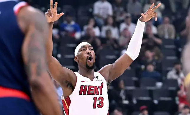 Miami Heat forward Bam Adebayo (13) celebrates his three-pointer against the Los Angeles Clippers during the first half of an NBA basketball game, Monday, Nov. 3, 2025, in Los Angeles. (AP Photo/Wally Skalij)
