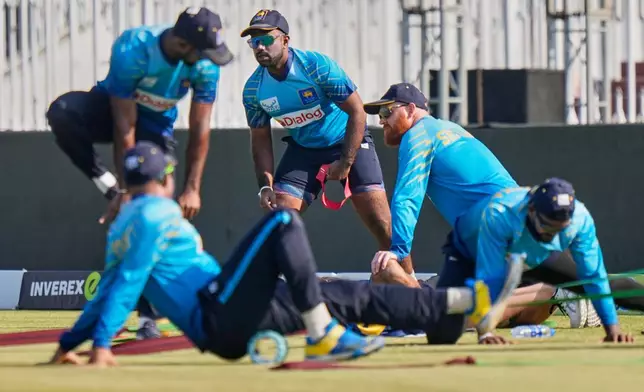 Sri Lanka's ODI team skipper Charith Asalanka, center back, and teammates warm up before start of the first one day international cricket match between Pakistan and Sri Lanka, in Rawalpindi, Pakistan, Tuesday, Nov. 11, 2025. (AP Photo/Anjum Naveed)