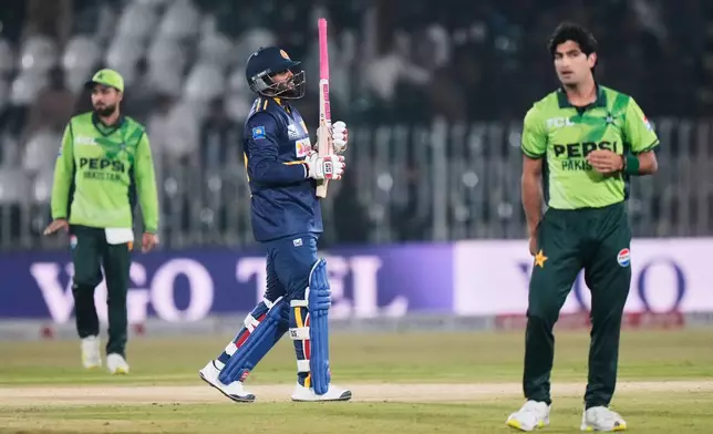 Sri Lanka's Wanindu Hasaranga, center, reacts after he dismissed by Pakistan's Naseem Shah, right, during the first one day international cricket match between Pakistan and Sri Lanka, in Rawalpindi, Pakistan, Tuesday, Nov. 11, 2025. (AP Photo/Anjum Naveed)