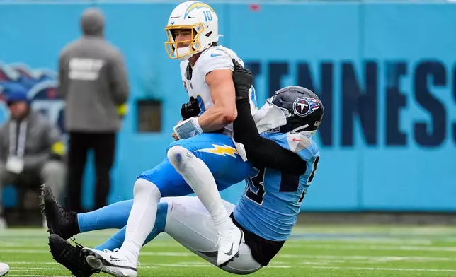 Los Angeles Chargers quarterback Justin Herbert (10) is sacked by Tennessee Titans linebacker Jihad Ward (53) during the second half of an NFL football game Sunday, Nov. 2, 2025, in Nashville, Tenn. (AP Photo/George Walker IV)