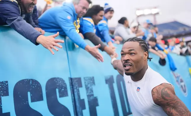 Los Angeles Chargers safety Derwin James Jr. (3) shakes hands with fans as he walks off the field after a win over the Tennessee Titans in an NFL football game Sunday, Nov. 2, 2025, in Nashville, Tenn. (AP Photo/George Walker IV)