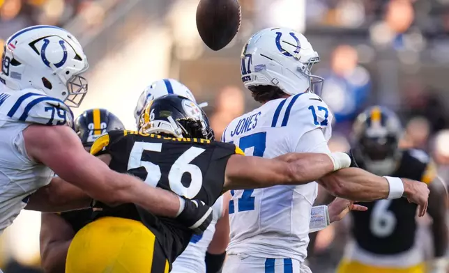 Pittsburgh Steelers linebacker Alex Highsmith (56) forces a fumble by Indianapolis Colts quarterback Daniel Jones (17) during the second half of an NFL football game in Pittsburgh, Sunday, Nov. 2, 2025. (AP Photo/Gene J. Puskar)