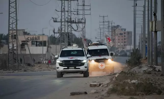 Red Cross vehicles carrying the bodies of two people believed to be deceased hostages handed over by Hamas make their way toward the Kissufim border crossing with Israel, to be transferred to Israeli authorities, in Deir al-Balah, central Gaza Strip, Thursday, Oct. 30, 2025. (AP Photo/Abdel Kareem Hana)