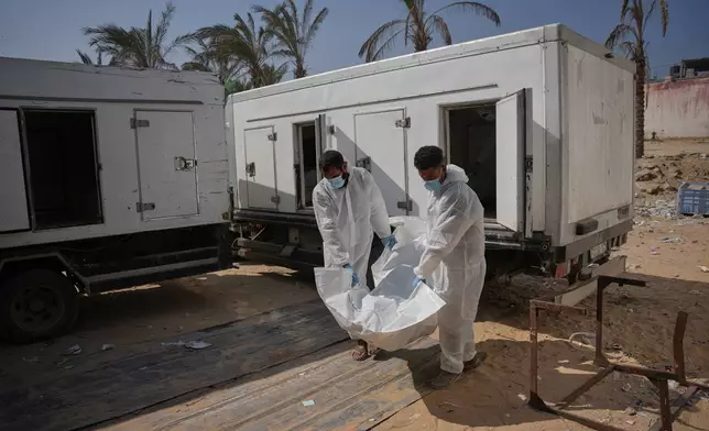 Bodies of unidentified Palestinians returned from Israel as part of the ceasefire deal are brought to Nasser Hospital in Khan Younis, Gaza Strip, Friday, Oct. 31, 2025. (AP Photo/Abdel Kareem Hana)