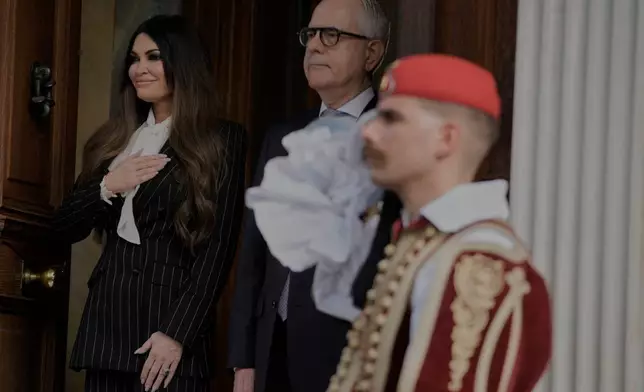 Kimberly Guilfoyle, the new U.S. Ambassador to Greece and first woman to hold the post, listen the national anthem next to Ambassador Dimitrios Zevelakis during a ceremony to present her diplomatic credentials at the Presidential Palace in Athens, Greece, Tuesday, Nov. 4, 2025. (AP Photo/Petros Giannakouris)