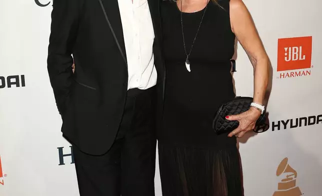 FILE - Richard Branson, left, and Joan Templeman Branson appear at the 2016 Clive Davis Pre-Grammy Gala in Beverly Hills, Calif., Feb. 14, 2016. (Photo by John Salangsang/Invision/AP, File)