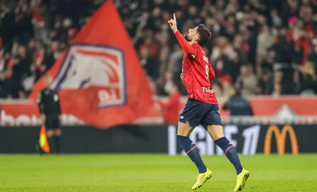 Lille's Olivier Giroud celebrates after scoring his side's first goal during the French League One soccer match between Lille and Paris FC in Lille, France, Sunday Nov. 23, 2025. (AP Photo/Jean-Francois Badias)