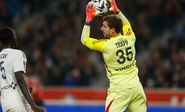 Paris FC's goalkeeper Trapp Kevin catches the ball during the French League One soccer match between Lille and Paris FC in Lille, France, Sunday Nov. 23, 2025. (AP Photo/Jean-Francois Badias)