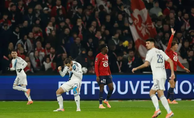 Paris FC's Marchetti Vincent, second left, celebrates the opening goal during the French League One soccer match between Lille and Paris FC in Lille, France, Sunday Nov. 23, 2025. (AP Photo/Jean-Francois Badias)