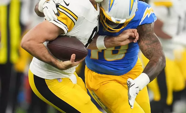 Los Angeles Chargers linebacker Bud Dupree (48) tackles Pittsburgh Steelers quarterback Aaron Rodgers (8) during the first half of an NFL football game Sunday, Nov. 9, 2025, in Inglewood, Calif. (AP Photo/Marcio Jose Sanchez)