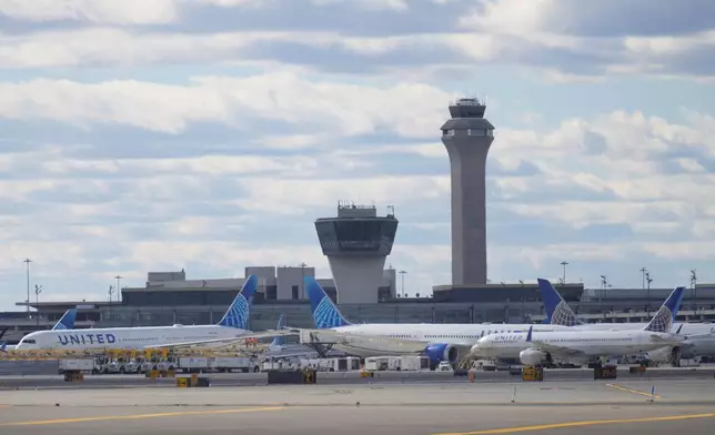 Planes are seen in front of an air traffic control tower at Newark International Airport in Newark, N.J., Thursday, Nov. 6, 2025. (AP Photo/Seth Wenig)