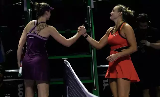 Elena Rybakina of Kazakhstan greets Aryna Sabalenka of Belarus after defeating her in the women's final singles match of the WTA finals in Riyadh, Saudi Arabia, Saturday, Nov. 8, 2025. (AP Photo/ Fatima Shbair)
