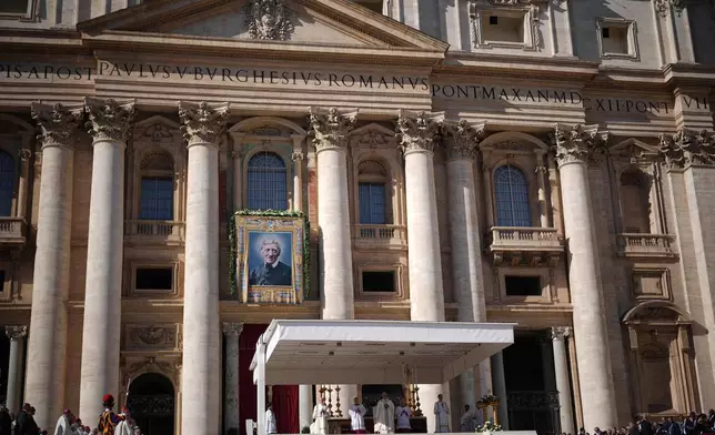 Pope Leo XIV presides over Mass with participants in the Jubilee of the Educational World on the Solemnity of All Saints, in St. Peter's Square, at the Vatican, Saturday, Nov. 1, 2025, during which he will proclaim St. John Henry Newman a Doctor of the Church. (AP Photo/Andrew Medichini)