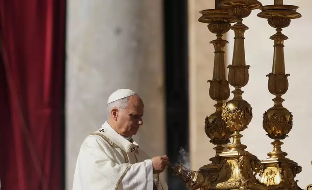 Pope Leo XIV presides over Mass with participants in the Jubilee of the Educational World on the Solemnity of All Saints, in St. Peter's Square, at the Vatican, Saturday, Nov. 1, 2025, during which he will proclaim St. John Henry Newman a Doctor of the Church. (AP Photo/Andrew Medichini)