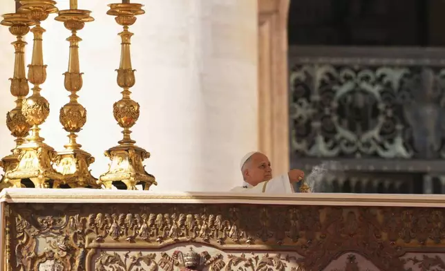 Pope Leo XIV presides over Mass with participants in the Jubilee of the Educational World on the Solemnity of All Saints, in St. Peter's Square, at the Vatican, Saturday, Nov. 1, 2025, during which he will proclaim St. John Henry Newman a Doctor of the Church. (AP Photo/Andrew Medichini)