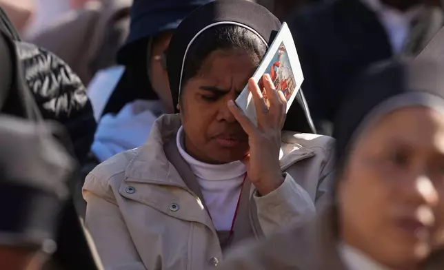 A nun attends a Mass with Pope Leo XIV and the Jubilee of the Educational World on the Solemnity of All Saints, in St. Peter's Square, at the Vatican, Saturday, Nov. 1, 2025, during which he will proclaim St. John Henry Newman a Doctor of the Church. (AP Photo/Andrew Medichini)