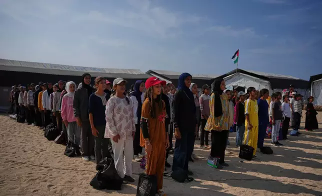 Students attend a morning assembly at a school set up on the beach in Khan Younis, southern Gaza Strip, Wednesday, Nov. 12, 2025. (AP Photo/Abdel Kareem Hana)