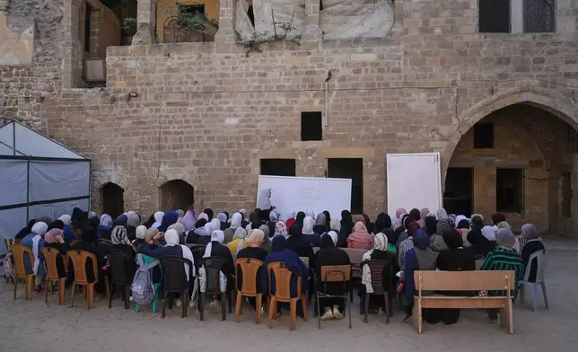 Palestinian high school students return to class, weeks after a ceasefire was announced between Israel and Hamas, at the Kamilia School in the Old City of Gaza City, Wednesday, Nov. 12, 2025. (AP Photo/Jehand Alshrafi)