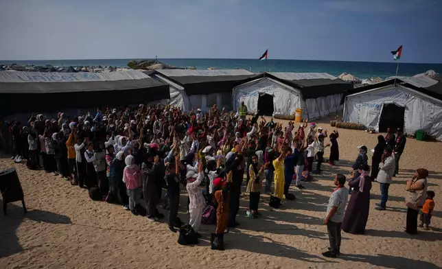 Students attend a morning assembly at a school set up on the beach in Khan Younis, southern Gaza Strip, Wednesday, Nov. 12, 2025. (AP Photo/Abdel Kareem Hana)