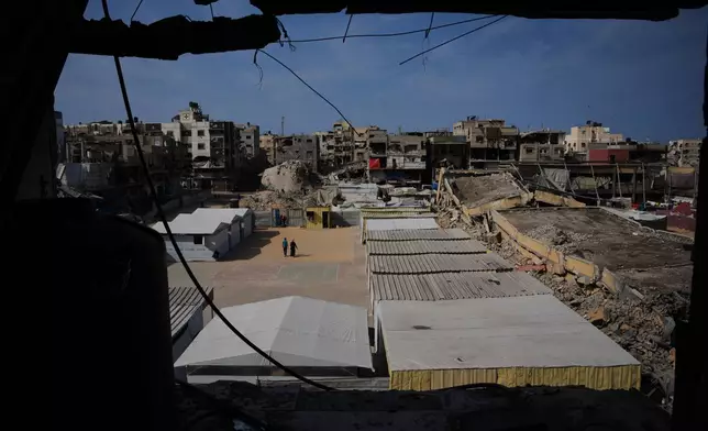 A view of a school surrounded by buildings destroyed during Israeli air and ground operation in Khan Younis, southern Gaza Strip, Wednesday, Nov. 12, 2025. (AP Photo/Abdel Kareem Hana)