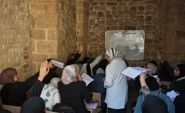 Palestinian high school students return to class weeks after a ceasefire was announced between Israel and Hamas, at the Kamilia School in the Old City of Gaza City, Wednesday, Nov. 12, 2025. (AP Photo/Jehand Alshrafi)