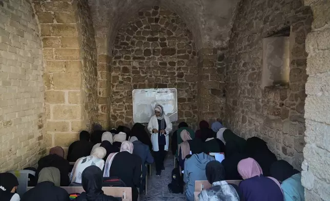Palestinian high school students return to class, weeks after a ceasefire was announced between Israel and Hamas, at the Kamilia School in the Old City of Gaza City, Wednesday, Nov. 12, 2025. (AP Photo/Jehand Alshrafi)