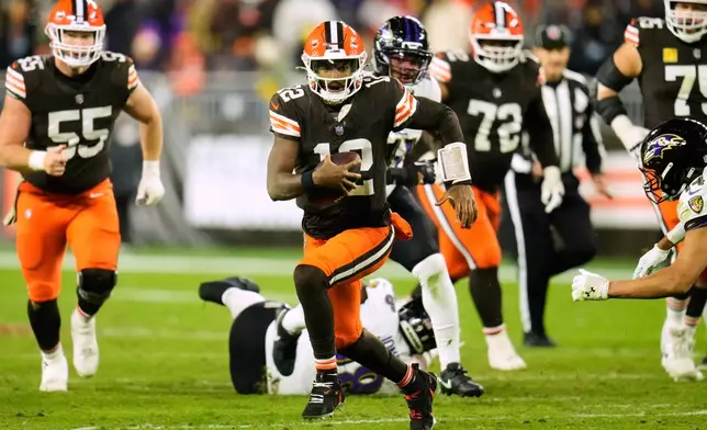 Cleveland Browns quarterback Shedeur Sanders (12) runs the ball in the second half of an NFL football game against the Baltimore Ravens in Cleveland, Sunday, Nov. 16, 2025. (AP Photo/Sue Ogrocki)