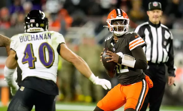 Cleveland Browns quarterback Shedeur Sanders (12) prepares to throw a pass under pressure from Baltimore Ravens linebacker Teddye Buchanan (40) in the second half of an NFL football game in Cleveland, Sunday, Nov. 16, 2025. (AP Photo/Sue Ogrocki)