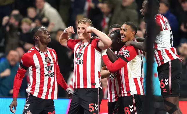 Sunderland's Daniel Ballard (second left) celebrates scoring his side's first goal during the English Premier League soccer match between Arsenal and Sunderland, in Sunderland, England, Saturday Nov. 8, 2025. (Owen Humphreys/PA via AP)