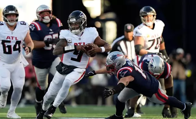 Atlanta Falcons quarterback Michael Penix Jr. (9) runs against the New England Patriots during the second half of an NFL football game, Sunday, Nov. 2, 2025, in Foxborough, Mass. (AP Photo/Robert F. Bukaty)