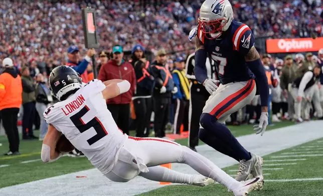 Atlanta Falcons wide receiver Drake London (5) scores a touchdown against the New England Patriots during the second half of an NFL football game, Sunday, Nov. 2, 2025, in Foxborough, Mass. (AP Photo/Charles Krupa)