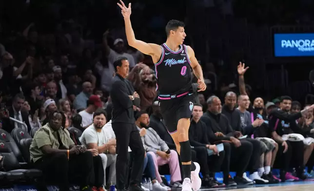 Miami Heat forward Simone Fontecchio (0) reacts after shooting a 3-pointer during the first half of an NBA basketball game against the New York Knicks, Monday, Nov. 17, 2025, in Miami. (AP Photo/Lynne Sladky)