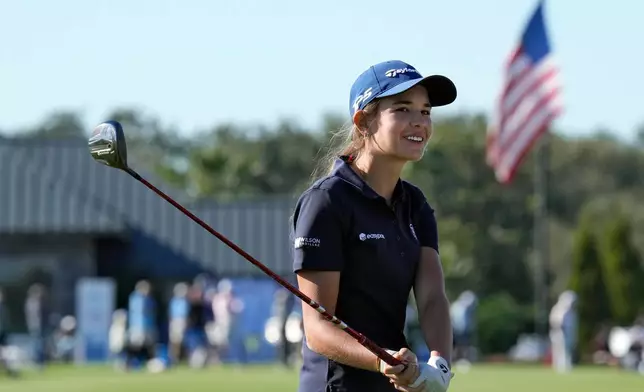 Kai Trump, granddaughter of President Donald Trump, smiles as she waits to hit from the 18th fairway during the first round of The Annika LPGA golf tournament Thursday, Nov. 13, 2025, in Belleair, Fla. (AP Photo/Chris O'Meara)