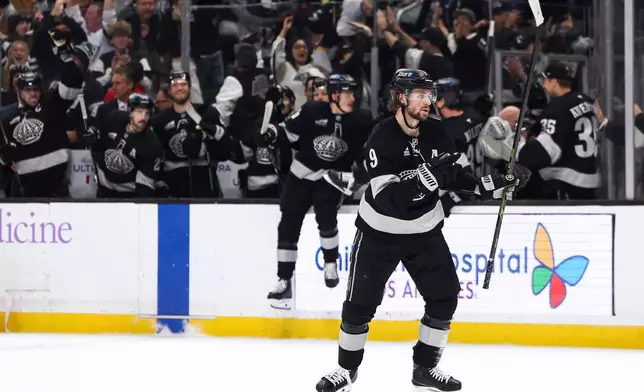 Los Angeles Kings right wing Adrian Kempe (9) celebrates after scoring the game winning goal during overtime of an NHL hockey game against the Vancouver Canucks, Saturday, Nov. 29, 2025, in Los Angeles. (AP Photo/Jessie Alcheh)