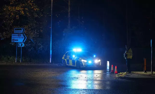 Police work at the Huntingdon, England, train station in Cambridgeshire, after people were stabbed on a train, Saturday, Nov. 1, 2025. (Chris Radburn/PA via AP)
