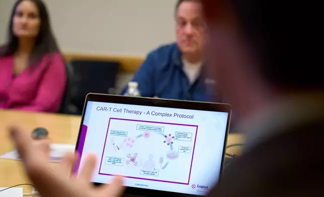 A graphic explaining CAR-T cell therapy is displayed on the laptop of Dr. Roberto Caricchio, director of the Lupus Center at UMass Chan Medical School, as he speaks to a lupus support group at its campus, Wednesday, Feb. 12, 2025, in Worcester, Mass. (AP Photo/David Goldman)