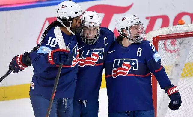 United States forward Hilary Knight, center, celebrates with defensewoman Laila Edwards, left, and forward Alex Carpenter (25) after scoring during the third period of a Rivalry Series women's hockey game against Canada, Saturday, Nov. 8, 2025, in Buffalo, N.Y. (AP Photo/Adrian Kraus)
