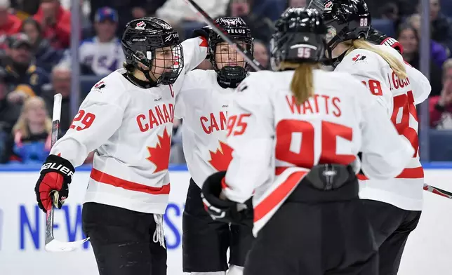 Canada forward Marie-Philip Poulin, left, celebrates with defensewoman Renata Fast, second from left, forward Daryl Watts (95) and forward Julia Gosling after scoring during the second period of a Rivalry Series women's hockey game against the United States, Saturday, Nov. 8, 2025, in Buffalo, N.Y. (AP Photo/Adrian Kraus)